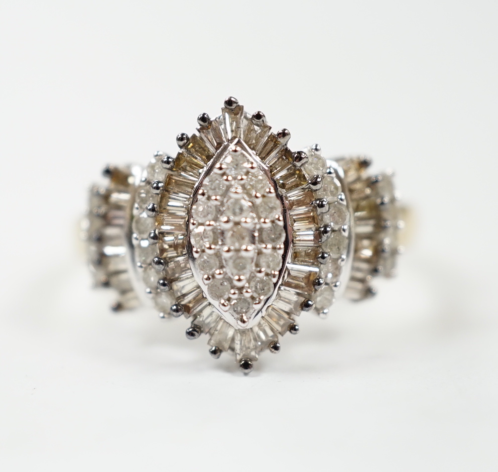 A modern 9ct gold and diamond navette shaped cluster dress ring, set with baguette and round cut stones and diamond cluster set shoulders, size O/P, gross weight 3.2 grams.